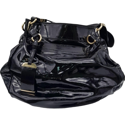 555 - Jimmy Choo Black Patent Leather Handbag.
Gorgeous feel to this handbag. Double strapped, with engrav... 
