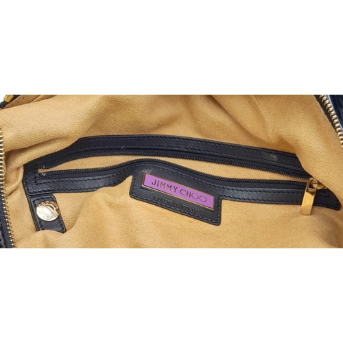 555 - Jimmy Choo Black Patent Leather Handbag.
Gorgeous feel to this handbag. Double strapped, with engrav... 