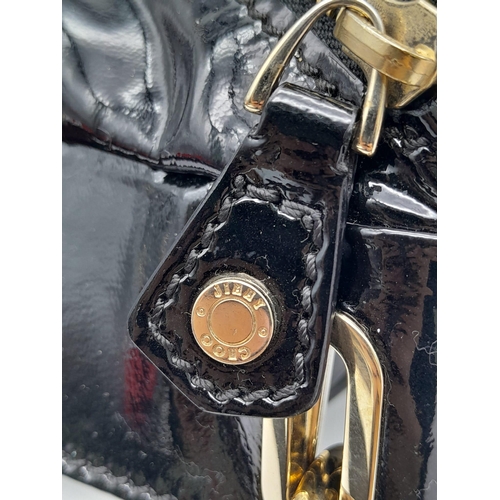 555 - Jimmy Choo Black Patent Leather Handbag.
Gorgeous feel to this handbag. Double strapped, with engrav... 