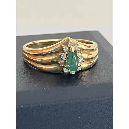 588 - 9 carat GOLD RING having a triple wishbone top,set with a GREEN TOURMALINE and a DIAMOND surround. F... 