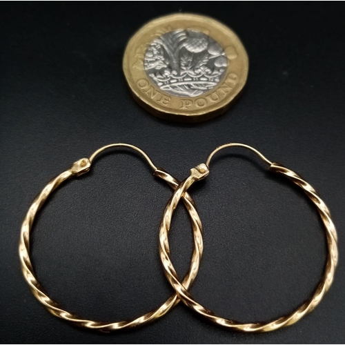 446 - A Pair of 14K Yellow Gold Hoop Earrings. Twist decoration. 25mm diameter. 1.56g weight.