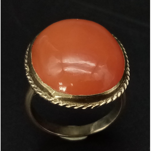 485 - An Antique 9K Yellow Gold and Carnelian Ring. A rich cognac coloured carnelian cabochon. Size K. 6.0... 