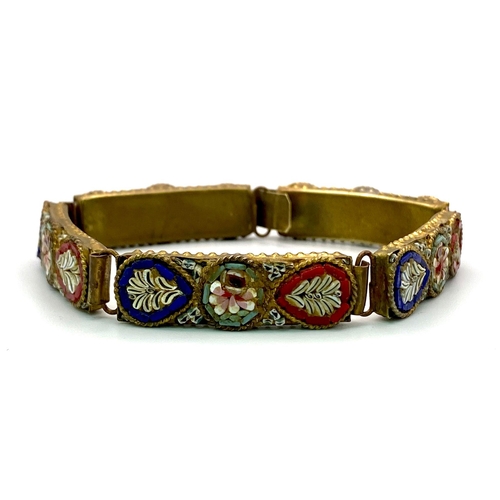 750 - Vintage micro-mosaic bracelet made in Italy. 
The bracelet has a brass shell with little round flora... 