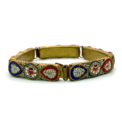 750 - Vintage micro-mosaic bracelet made in Italy. 
The bracelet has a brass shell with little round flora... 