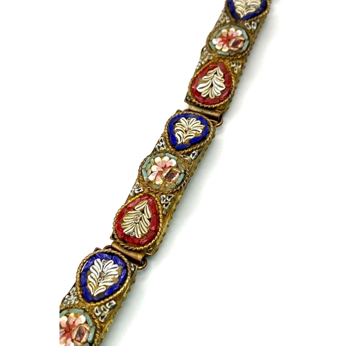 750 - Vintage micro-mosaic bracelet made in Italy. 
The bracelet has a brass shell with little round flora... 