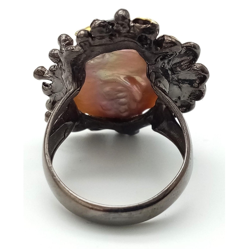 125 - A unique design, a sterling silver with black patina ring with a massive, baroque, white, natural pe... 