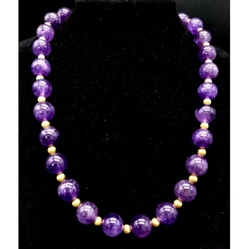 188 - A fashionable, heavily gilded amethyst necklace and earrings set in a presentation case. Very good c... 