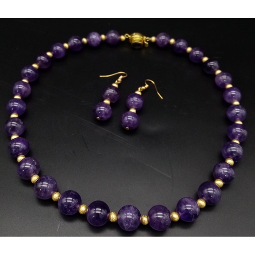 188 - A fashionable, heavily gilded amethyst necklace and earrings set in a presentation case. Very good c... 