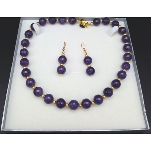 188 - A fashionable, heavily gilded amethyst necklace and earrings set in a presentation case. Very good c... 