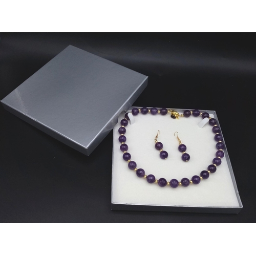 188 - A fashionable, heavily gilded amethyst necklace and earrings set in a presentation case. Very good c... 