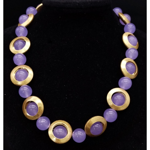 216 - A 60s style necklace with lavender jade beads surrounded by a gilded halo, accompanied by a pair of ... 