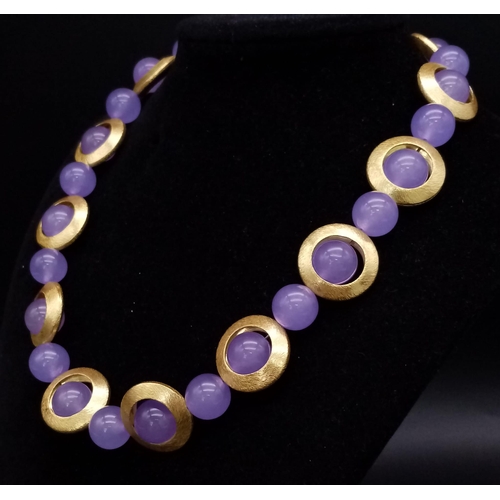 216 - A 60s style necklace with lavender jade beads surrounded by a gilded halo, accompanied by a pair of ... 