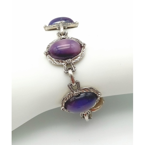 230 - A wonderful example of a vintage, mesmerising, purple cat’s eyes bracelet, in a presentation case: L... 