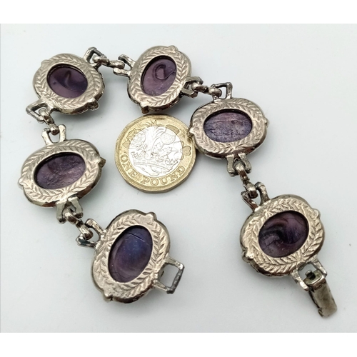 230 - A wonderful example of a vintage, mesmerising, purple cat’s eyes bracelet, in a presentation case: L... 