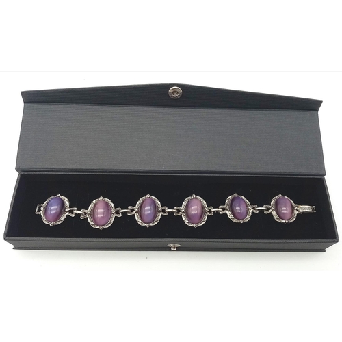 230 - A wonderful example of a vintage, mesmerising, purple cat’s eyes bracelet, in a presentation case: L... 