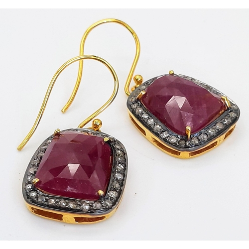 310 - A Pair of Unusual Drop Earrings set with Large Rubies and Diamond Halos - Fish hook fittings in silv... 