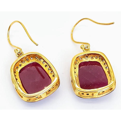 310 - A Pair of Unusual Drop Earrings set with Large Rubies and Diamond Halos - Fish hook fittings in silv... 