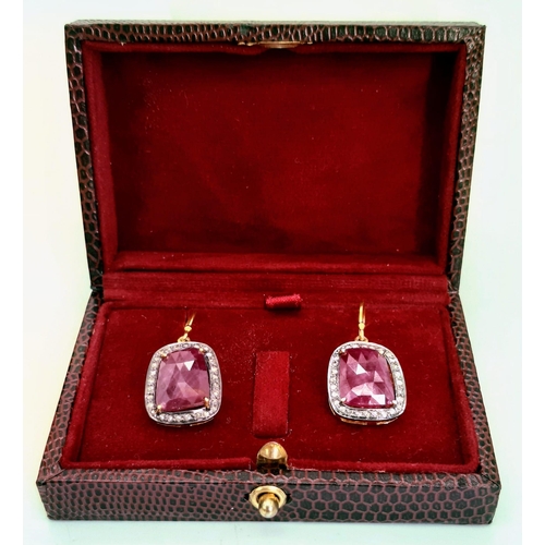 310 - A Pair of Unusual Drop Earrings set with Large Rubies and Diamond Halos - Fish hook fittings in silv... 