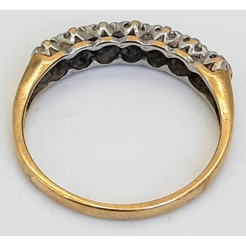 477 - A Vintage 9K Yellow Gold Diamond Ring. Seven small stones.
Size I/J. 1.15g total weight.