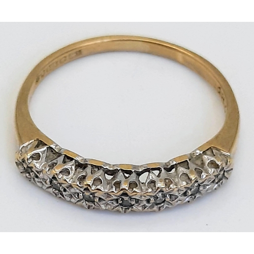 477 - A Vintage 9K Yellow Gold Diamond Ring. Seven small stones.
Size I/J. 1.15g total weight.