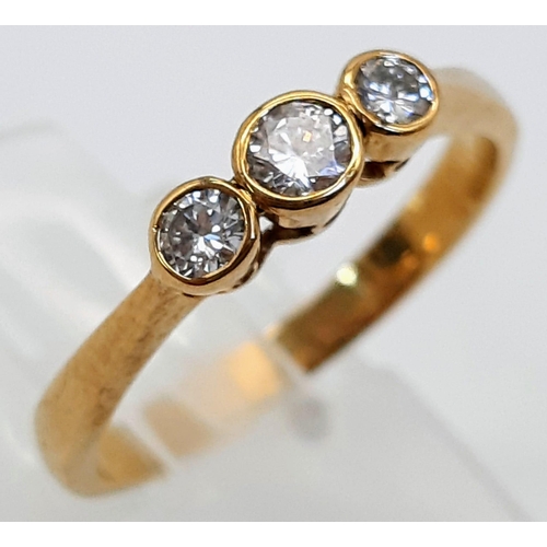 790 - A 9K Yellow Gold and Diamond Rub Over Set Trilogy Ring. Boxed. Brilliant round cut diamonds - 0.40ct... 