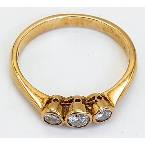 790 - A 9K Yellow Gold and Diamond Rub Over Set Trilogy Ring. Boxed. Brilliant round cut diamonds - 0.40ct... 