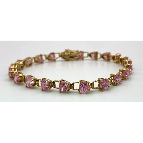 85 - A 9K Yellow Gold Pink CZ Tennis Bracelet. 19cm. 8.86g total weight.