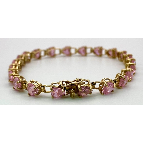 85 - A 9K Yellow Gold Pink CZ Tennis Bracelet. 19cm. 8.86g total weight.