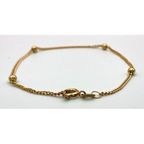 405 - A Delicate 9K Yellow Gold Bracelet with Ball Interrupters. 
18cm length. 1.31g weight.