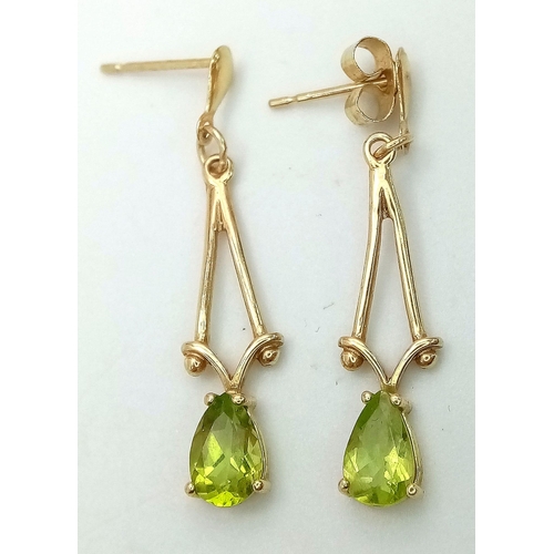 833 - A Pair of 9K Yellow Gold Peridot Drop Earrings. 2.5cm drop. 1.1g total weight.