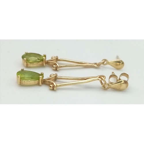 833 - A Pair of 9K Yellow Gold Peridot Drop Earrings. 2.5cm drop. 1.1g total weight.