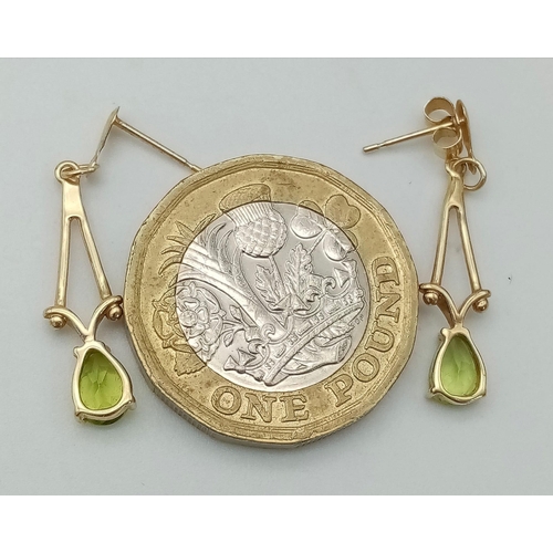 833 - A Pair of 9K Yellow Gold Peridot Drop Earrings. 2.5cm drop. 1.1g total weight.