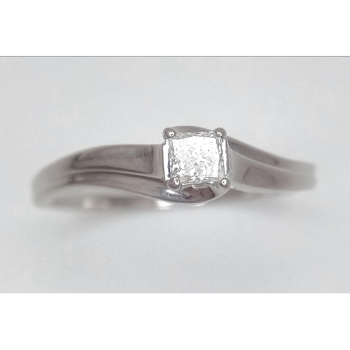 568 - A 9K White Gold Princess-Cut Diamond Solitaire Ring with Wave Shoulders . Diamond - 0.30ct. Size X/Y... 