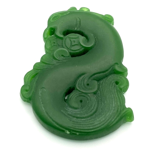 835 - A Chinese Green Jade Swirling Dragon Pendant. 5cm