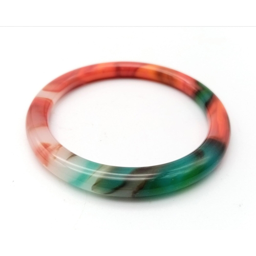 879 - A Multi-Coloured Thin Chinese Jade Bangle. 6cm inner diameter. 8mm width.