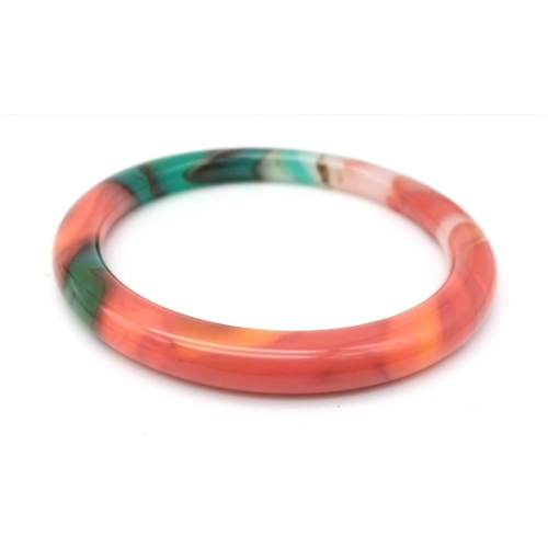 879 - A Multi-Coloured Thin Chinese Jade Bangle. 6cm inner diameter. 8mm width.