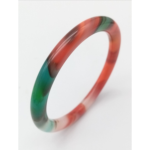 879 - A Multi-Coloured Thin Chinese Jade Bangle. 6cm inner diameter. 8mm width.