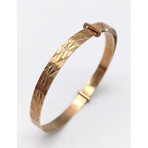 297 - A 9k Yellow Gold Expanding Baby Bangle With Pretty Geometric Pattern, Engraved With Name Lauren To T... 