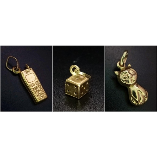 820 - Collection of 3, 9kt Yellow Gold Charms.
Featuring a perched Cat, a 90's mobile phone and a single d... 