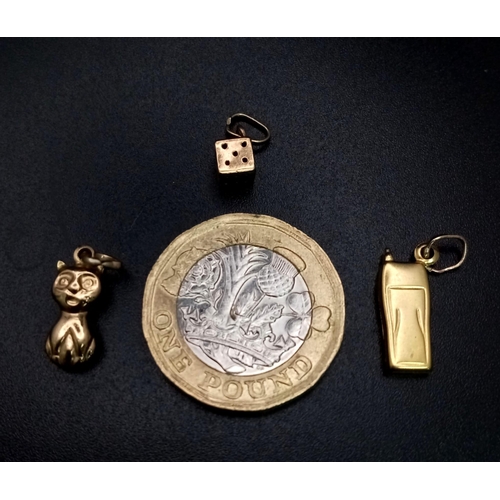 820 - Collection of 3, 9kt Yellow Gold Charms.
Featuring a perched Cat, a 90's mobile phone and a single d... 