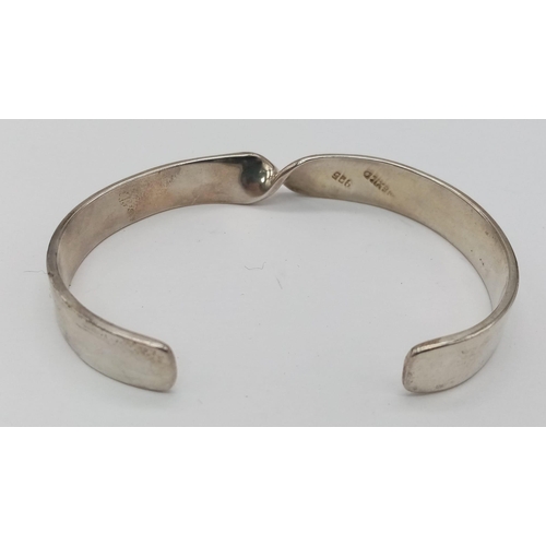 889 - A Sterling Silver Twist Bangle. 3cm opening gap, 22.4g weight.