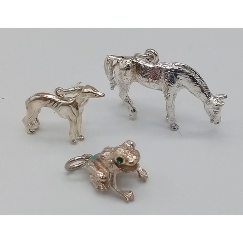 917 - Three Sterling Silver Animal Charms - a horse, dog, and frog with gem set eyes. 12.2g total weight.