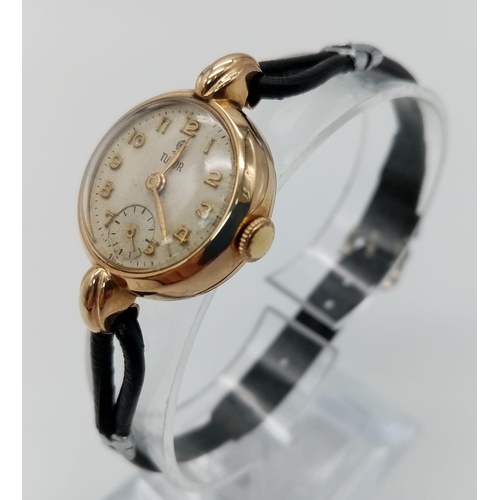 239 - A Vintage (1950s) 9K Gold Tudor Ladies Watch. Black leather strap. 9K gold case - 22mm. White dial w... 