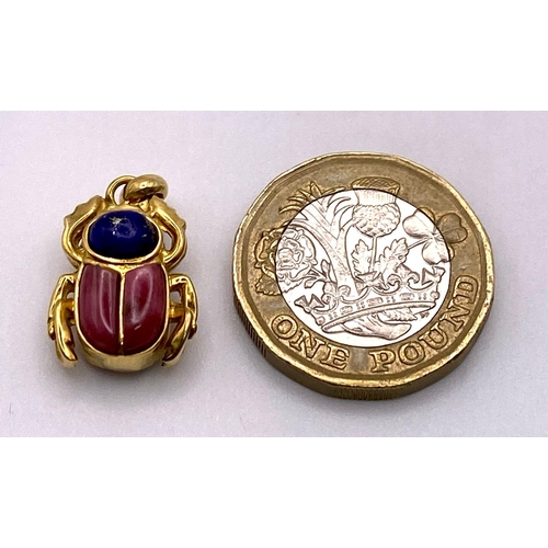 265 - An 18K Yellow Gold Double Sided Lapis and Coral Scarab Pendant. 5.7g total weight.