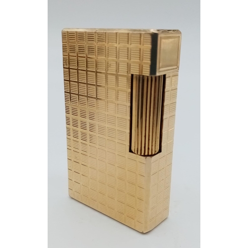 283 - A Vintage S. T. Dupont Gold Plated Lighter. Machined tooled geometric design. In good condition but ... 