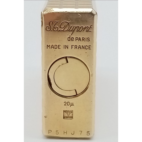 283 - A Vintage S. T. Dupont Gold Plated Lighter. Machined tooled geometric design. In good condition but ... 