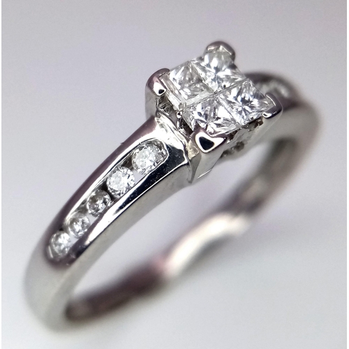 293 - An 18K White Gold Princess Cut Diamond Set Cluster Ring, with Brilliant Cut Diamond Shoulders. Size ... 