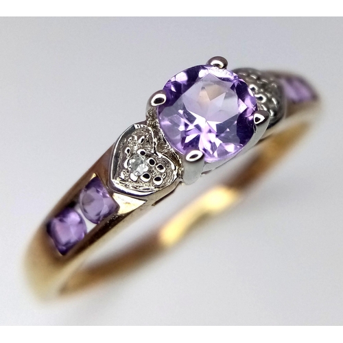 432 - A 9K Yellow Gold Diamond and Amethyst Ring with Heart Details on Shoulders. Size T. 0.02ctw diamonds... 