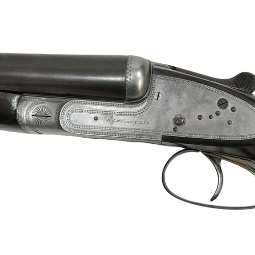 521 - A 12 GUAGE DOUBLE BARELLED SAWN OFF SHOTGUN MADE BY H.J.HUSSEY WITH SHORTENED STOCK .
COMES WITH CUR... 