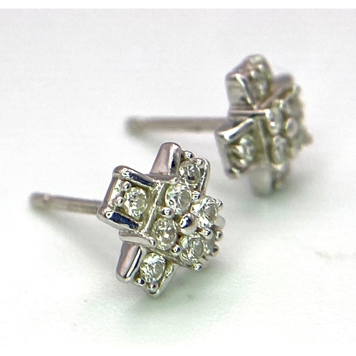 523 - A Pair of 10K White Gold Diamond Set Cross Earrings. No butterfly backs. 0.32ctw, 1g total weight.